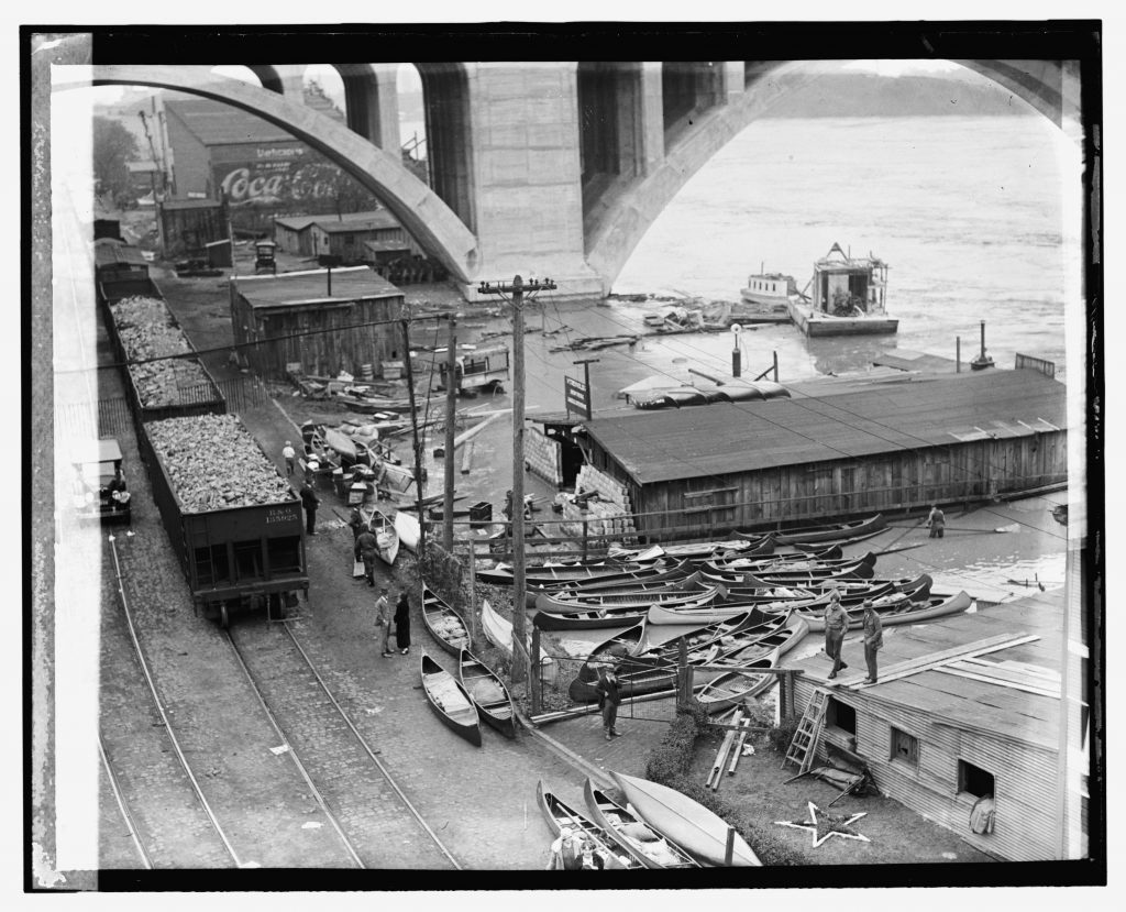 May 13, 2024. View from the Aqueduct bridge again, now facing east. Looking down on the boat yards adjacent to the Key Bridge, much of it washed away and damaged. B&O hopper 135925 and others sit loaded with aggregates, likely from the Smoot Sand & Gravel plant. 