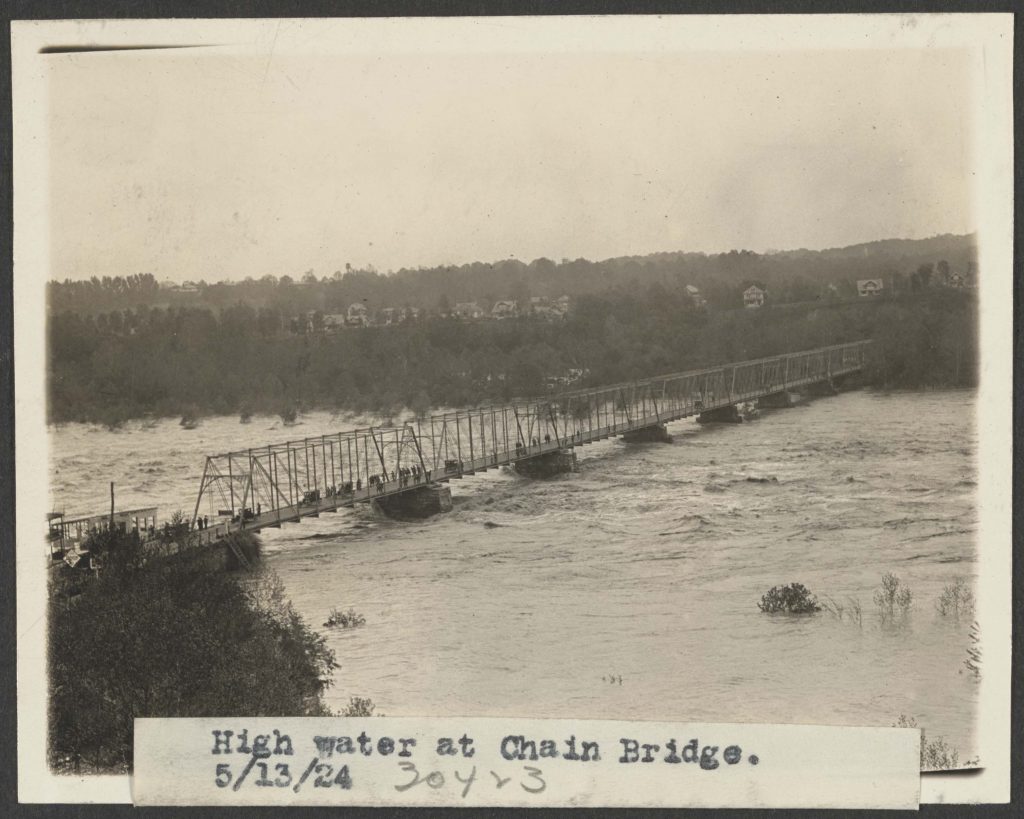 May 13, 2024. High Water at Chain Bridge. The B&O Georgetown Branch right of way is visible just above where the bridge makes landfall across the river, evidenced by the steep cut.